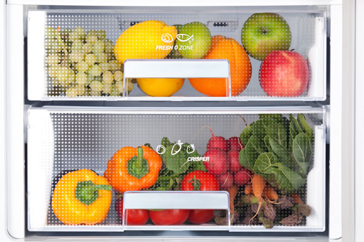 fresh vegetables and fruits in drawers of refrigerator